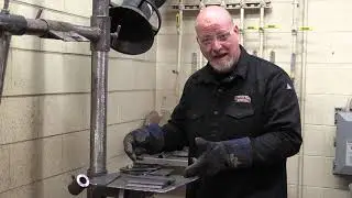 Prepping a V-groove butt with backing weld for certification bend testing.