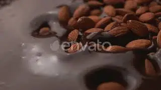 Almonds falling into chocolate in super slow motion, shot on Phantom Flex 4K | Stock Footage - E...