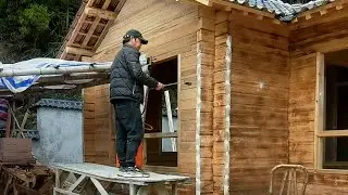 Skilled craftsmen built a beautiful wooden house on the hill with their own hands