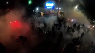 Protesters are subjected to massive gas and flash bang assault.