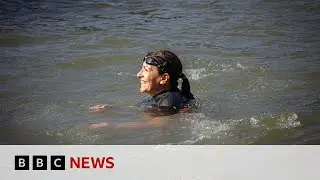 Paris mayor swims in Seine to prove water clean enough for Olympics | BBC News