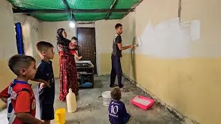 Rural family routine.  Babak paints the room after removing the wood-burning fireplace