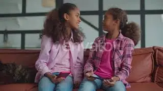 Cheerful Sisters Playing Staring Contest at Home | Stock Footage - Envato elements
