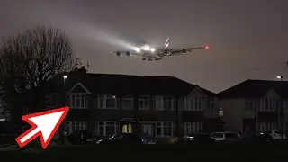 Airbus A380 landing at night time by flying low over houses