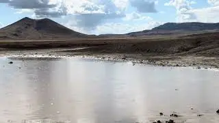 Raindrops Spatter on Muddy Playa Pond