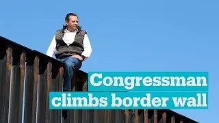 Mexican congressman climbs border wall to make a statement