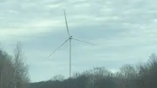 Wind Turbines spinning with blades at Windsor NY with cloudy skies