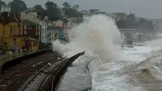 Dramatic scenes as huge waves batter Dawlish sea wall and station. Beach huts smashed.