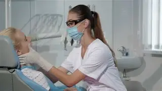 Female Dentist Begins The Checkup Of Her Patient At The Dentist Cabinet | Stock Footage