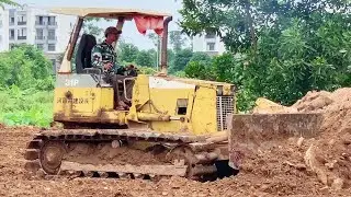 Bulldozer working - bulldozer leveling construction site