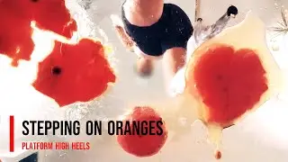 Stepping on a oranges with high heels 