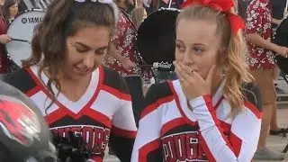 Football players kind gesture to cheerleader goes viral