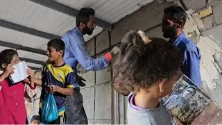 Printing a photo of Professor Mustafa's wife by the children's happiness cameraman