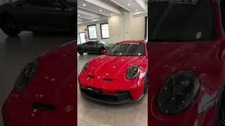 Hot brunette in minishort and red highheels shows a new Porsche. Sexy catwalk