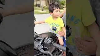 Little kid revving motorcycle engine