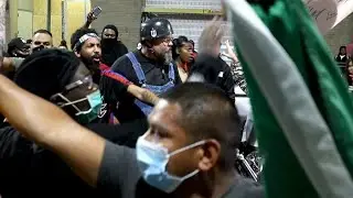 Demonstrators confront biker during protest