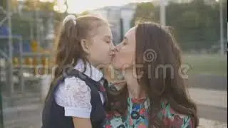 Cute Mother and School Daughter Kissing