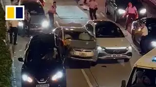 Driver tries to smash past Hong Kong roadblock in viral video