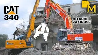 Caterpillar 340 high reach demolition excavator tearing down storage building Hitachi Zaxis 490