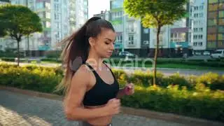 Muscular Woman Running in Morning City Streets. | Stock Footage - Envato elements