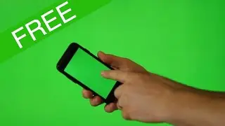 Hand holding mobile phone with green screen