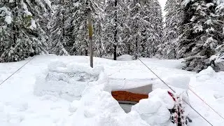 Winter Camping In Snow Shelter During A Storm