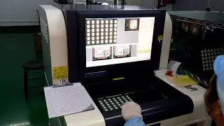 How operator working with offline AOI (Automated Optical Inspection) machine. Inspecting PCBA.