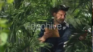 Adventurer in Hat using Tablet in Jungle Forest - Stock Footage | VideoHive 16730676