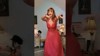 Dainty Rascal dancing in vintage red dress