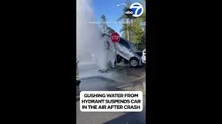 Car suspended in air by water gushing from fire hydrant after crash