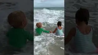 Toddlers playing in the water. Beach Funny Swimming!