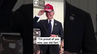 President Biden briefly puts on a Trump 2024 cap after he offered a Trump supporter to wear his hat