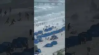 Footage captures waterspout ripping through crowded beach #Shorts