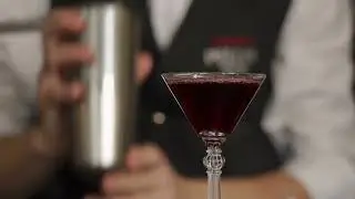 The bartender pours a full martini with wine 05 9