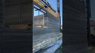 A construction robot is erecting a residential building. innovative technology.