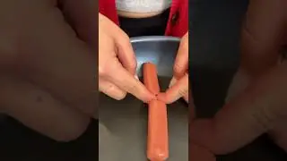 Woman cuts her sausage with nails 