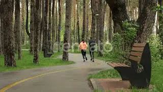 Sport couple running together in the park. Man and woman jogging in the rainy city park | Stock ...