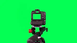 Dslr camera with green screen on the tripod isolated on green screen - free use