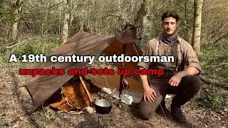 A 19th century outdoorsman unpacks and sets up camp