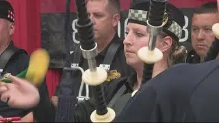 US Customs and Border Protection Honor Guard Pipes and Drums band perform outside a pub in Arlington