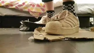 Giantess Zoé crushing cardboard box with Adidas Superstar and black and white checkered socks