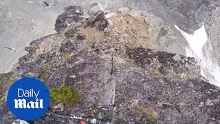 Mountain bike rider takes precarious path down rock face - Daily Mail