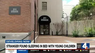 Stranger found sleeping in bed with young children