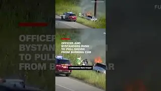 Officer and bystanders rush to pull driver from burning car