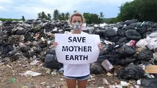 Environmental Activist Standing On Waste Landfill Holding Save Earth Poster | Stock Footage - En...