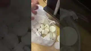 Shredding a bag of white bottle lids for recycling