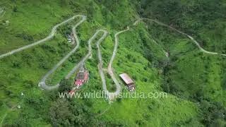 Dhaun village aerial view in Uttarakhand state, with winding hill roads & green cultivation around