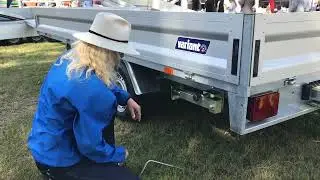 How to apply prop stands on a trailer - woman shows how.