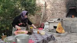 Cooking Dolmas(stuffed grape leaves)& eggplant jam on charcoal stove in an Iranian village in autumn