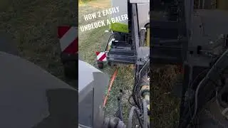 The easy way to unblock pickup reel on a baler with a ratchet strap